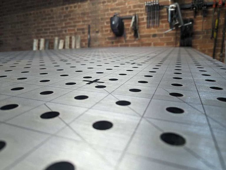 A close up view of a welding table is shown emphasizing etch lines on it.